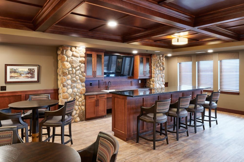 Elegant home bar with wood paneling and stone accents.