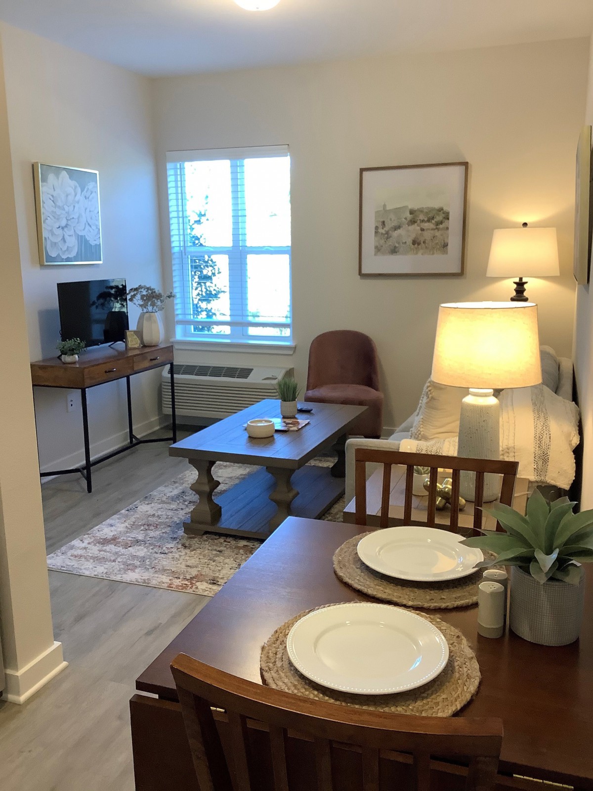 A cozy living and dining area with a warm lighting ambiance.