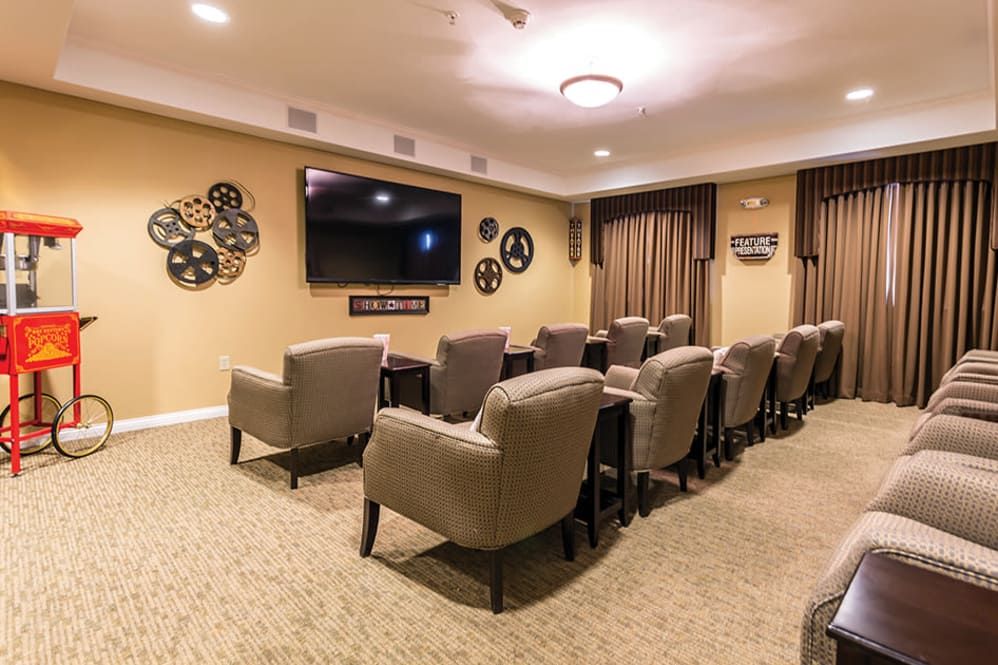 A cozy home theater with comfortable seating and a large screen.