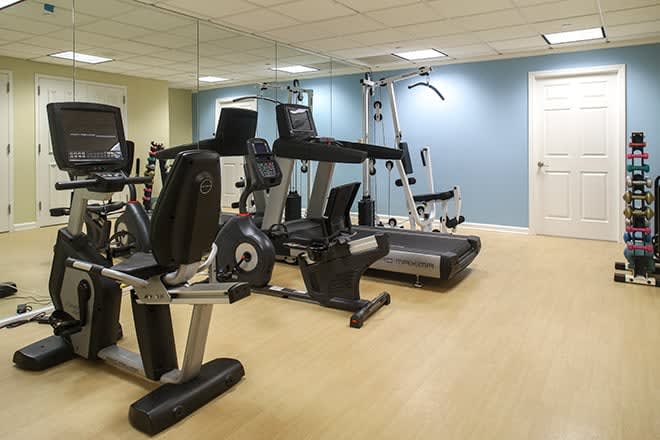 A well-equipped gym with various exercise machines.