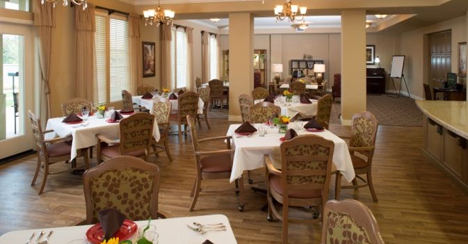 An elegant dining room with neatly arranged tables and chairs.