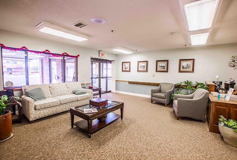 A cozy living room with sofas, chairs, and a coffee table.