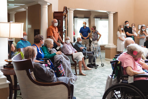 Residents and staff engaging in a social gathering at a senior living facility.
