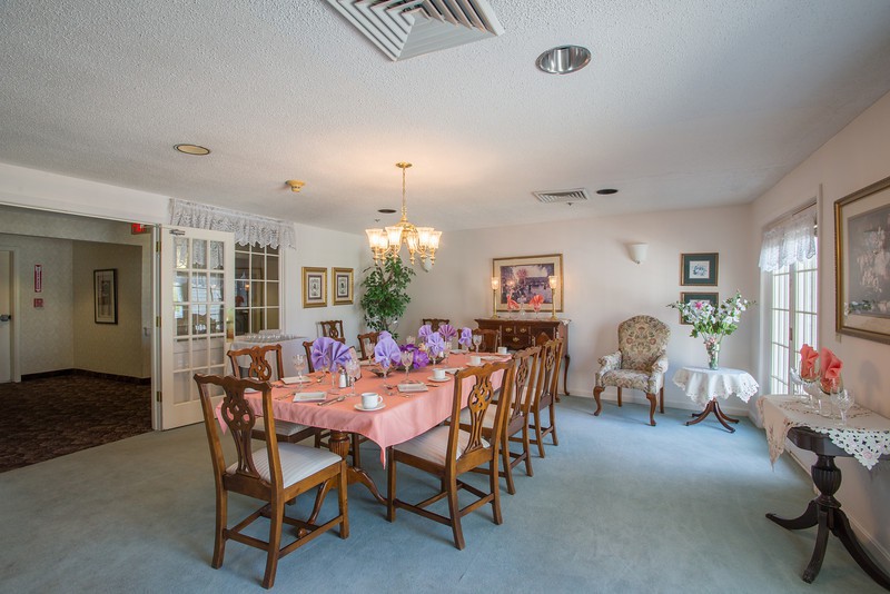 A beautifully set dining room with a large table and elegant furnishings.