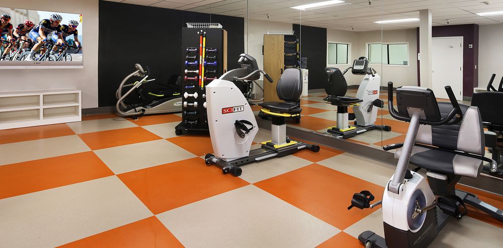 A modern gym featuring various exercise machines and equipment.
