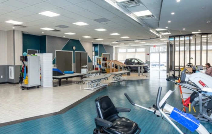 An indoor view of a rehabilitation center equipped with various physical therapy apparatus.