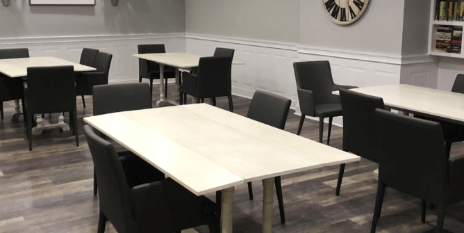 Modern dining area with neatly arranged tables and chairs.