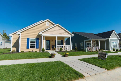 A charming suburban house with a well-kept front yard and clear blue skies.