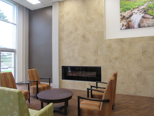 A cozy modern living room featuring comfortable seating and a stylish fireplace.