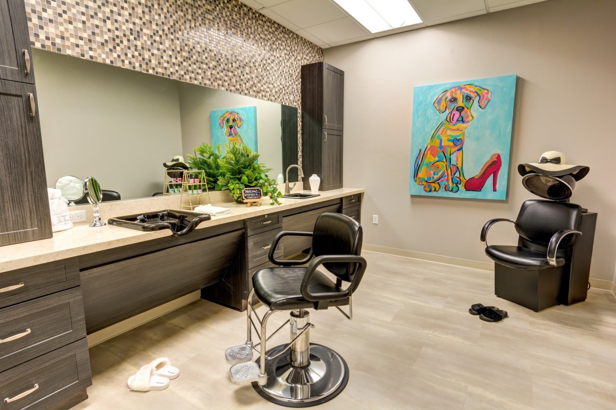 A modern hair salon interior featuring stylish decor and comfortable seating.