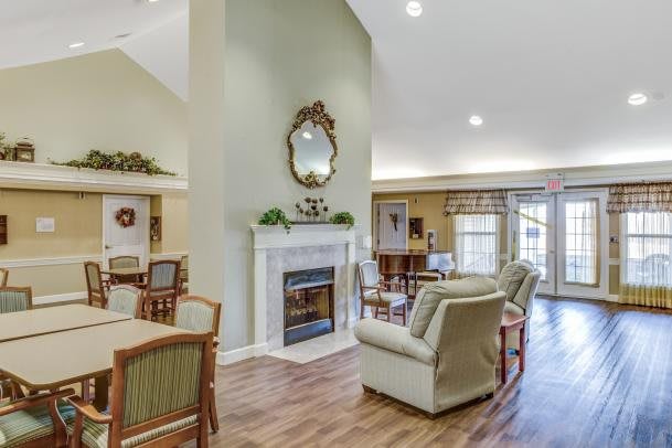 A cozy living room with a fireplace, comfortable seating, and elegant decor.