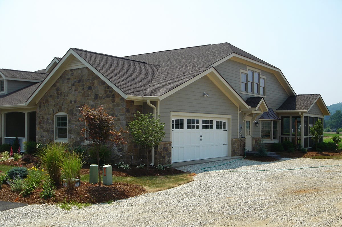 A modern suburban house featuring a stone facade and attached garage.