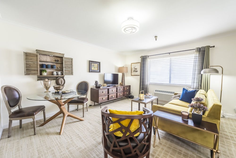 A modern living room with stylish furniture and warm lighting.