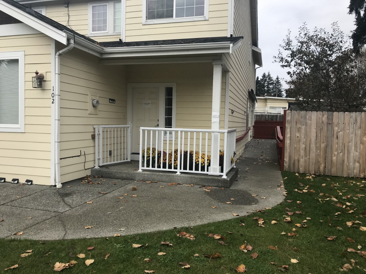 Residential house with a small front porch and driveway.