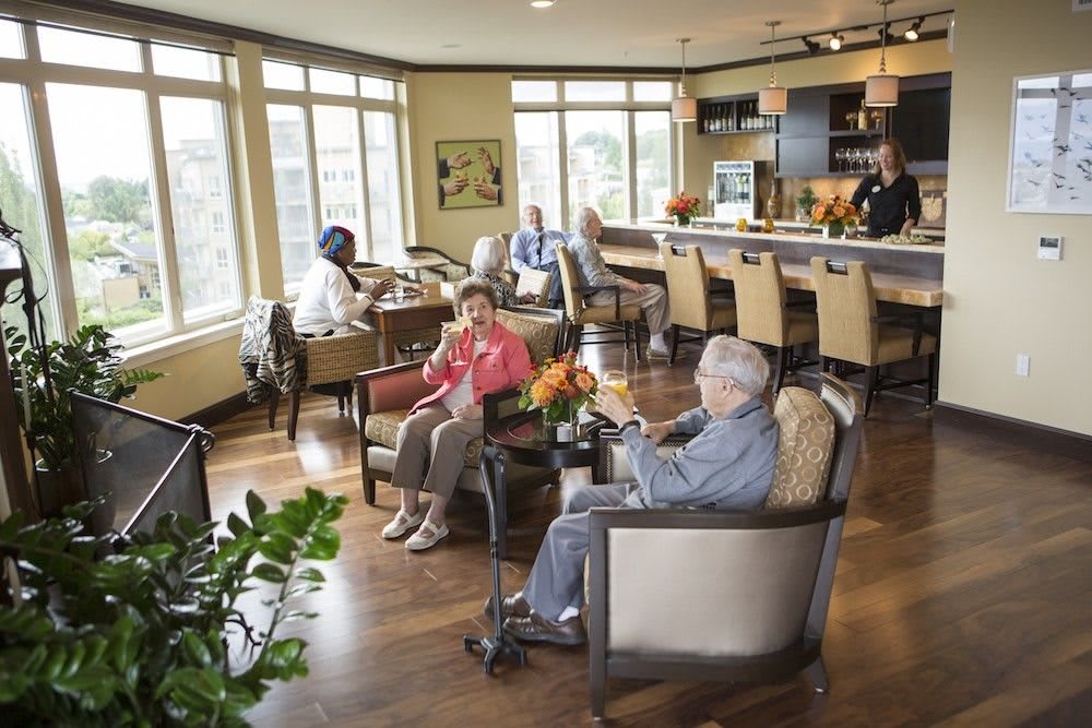 A cozy lounge with people socializing and enjoying beverages.