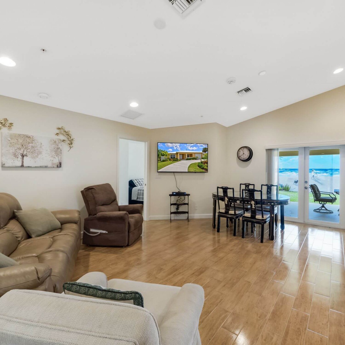 A spacious living room with comfortable seating and a dining area.