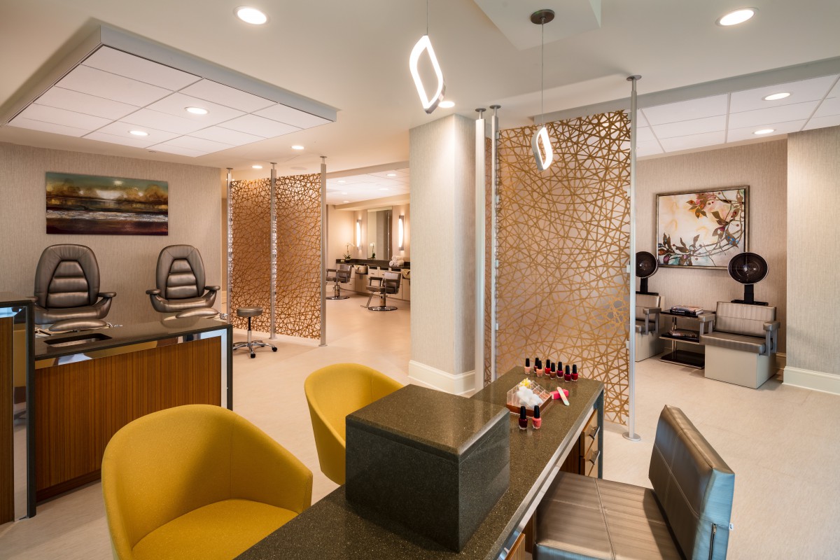 A modern salon interior with stylish seating and decorative panels.