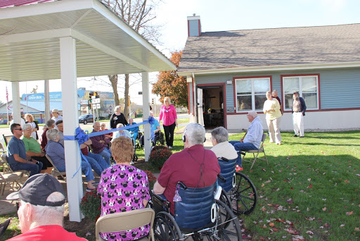 Seniors engaged in a community event outdoors, enjoying the sunny weather.