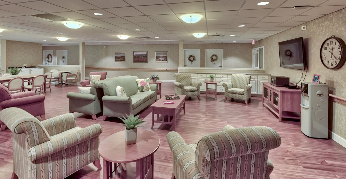 A cozy and well-furnished living room with sofas, armchairs, and coffee tables arranged in an inviting layout.