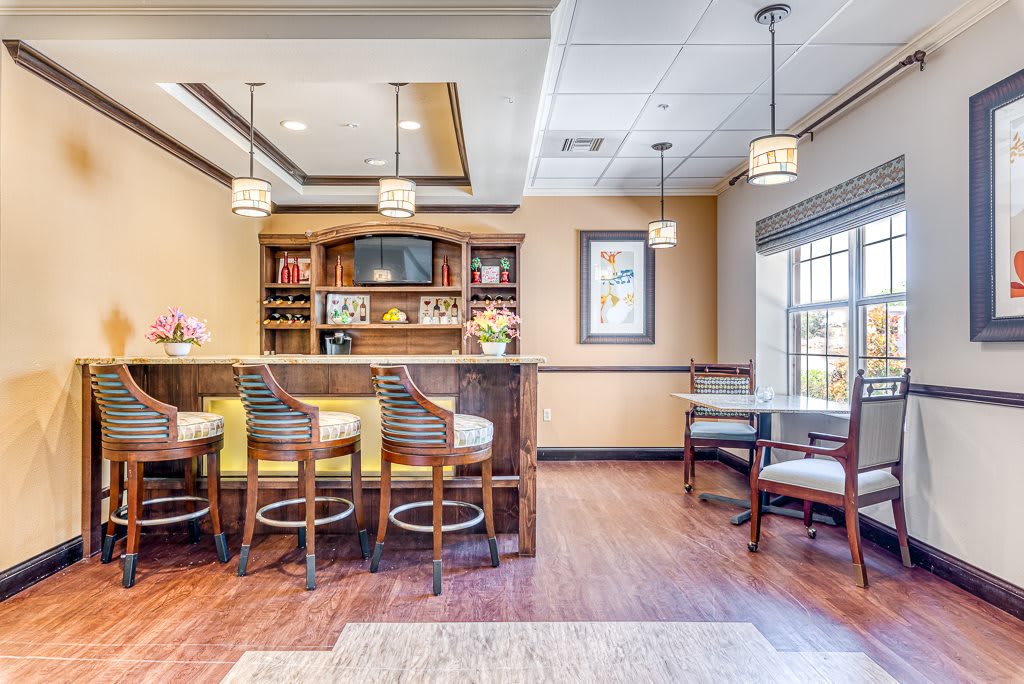 Cozy lounge area with a bar and seating arrangement in a modern interior design.