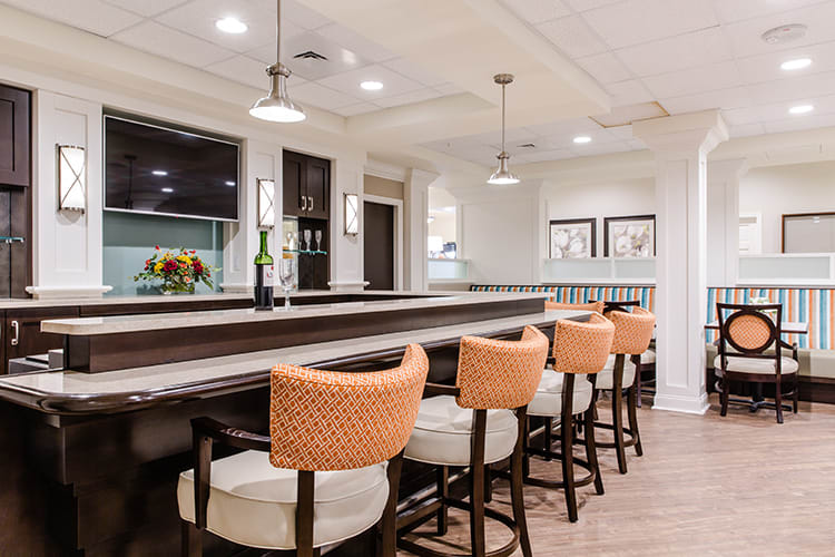 A modern bar interior with stylish seating and pendant lighting.