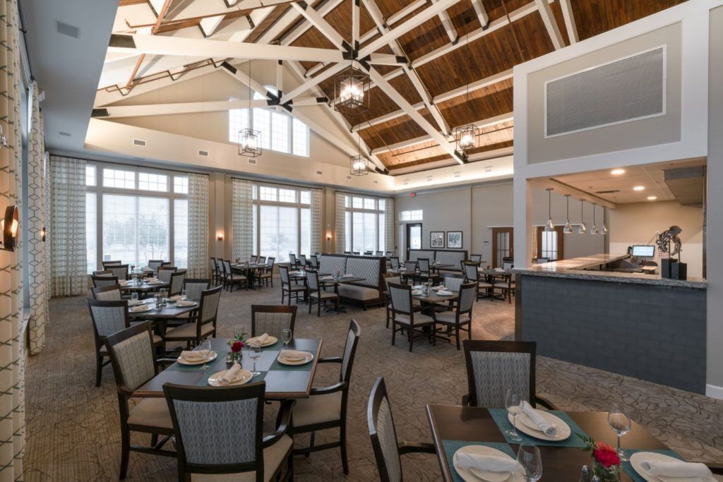 A spacious restaurant interior with natural lighting and modern design elements.