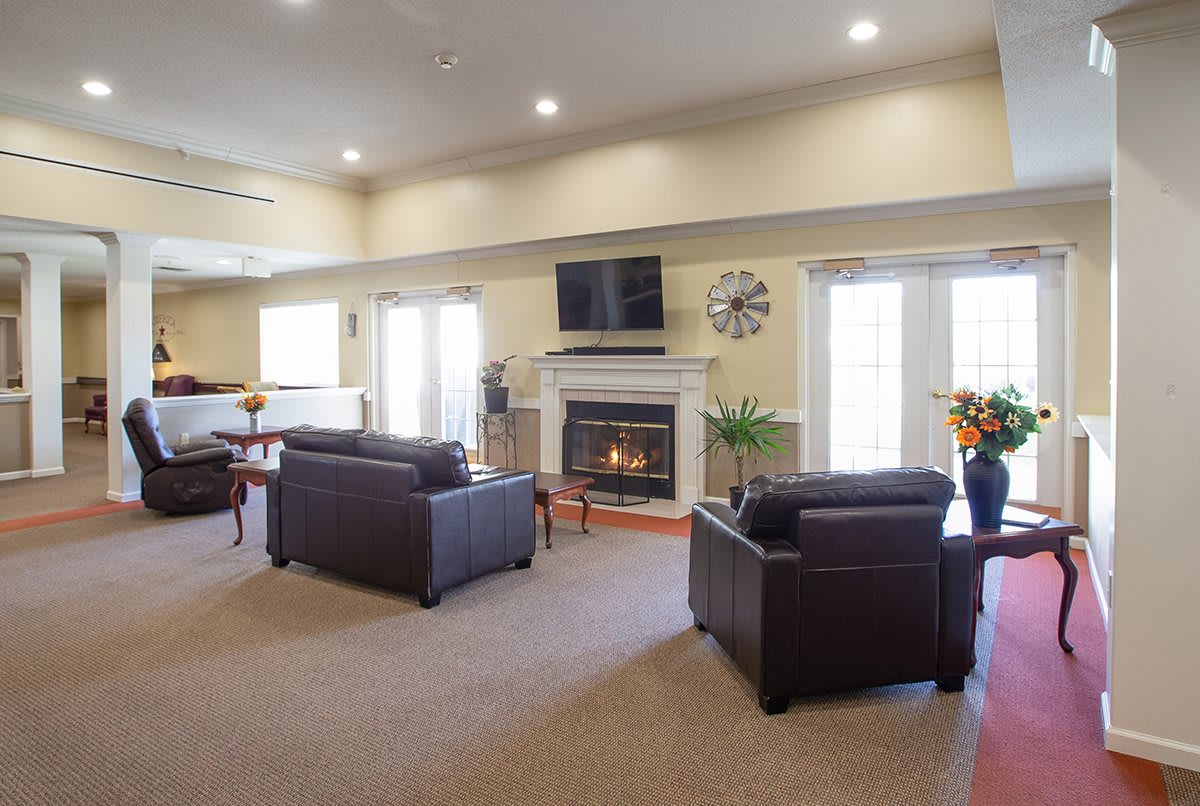 A cozy living room with a fireplace and comfortable seating.