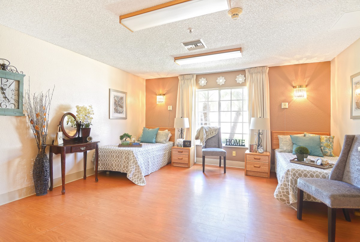 A cozy and well-lit bedroom with twin beds and decorative elements.
