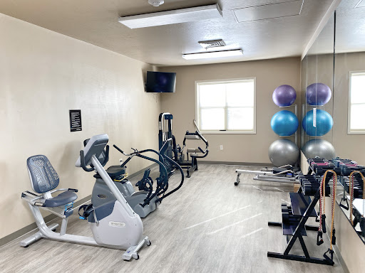 A well-equipped indoor gym featuring various exercise machines and fitness accessories.