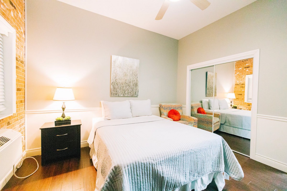 A cozy bedroom with a neatly made bed, soft lighting, and stylish decor.
