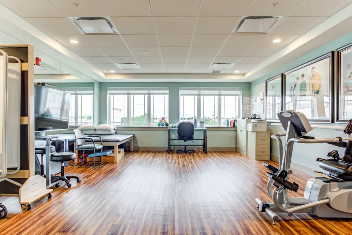 A clean and modern fitness center with exercise equipment and bright natural lighting.