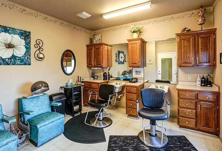 A cozy salon interior with styling chairs and mirrors.
