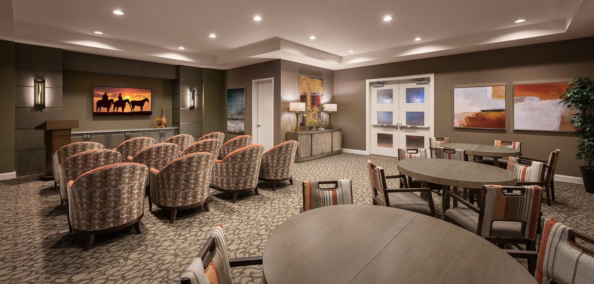 A well-lit conference room with arranged seating and tables for meetings.