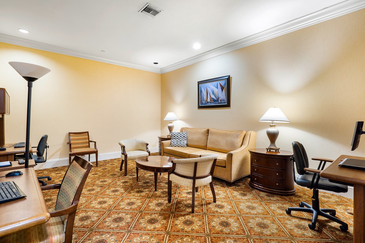 A cozy living room with a sofa, chairs, coffee table, and decorative lamps.
