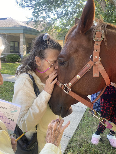 A heartwarming moment between a person and a horse, showcasing the bond between humans and animals.