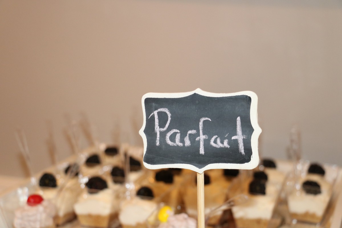 A display of parfaits with a chalkboard sign labeling them.