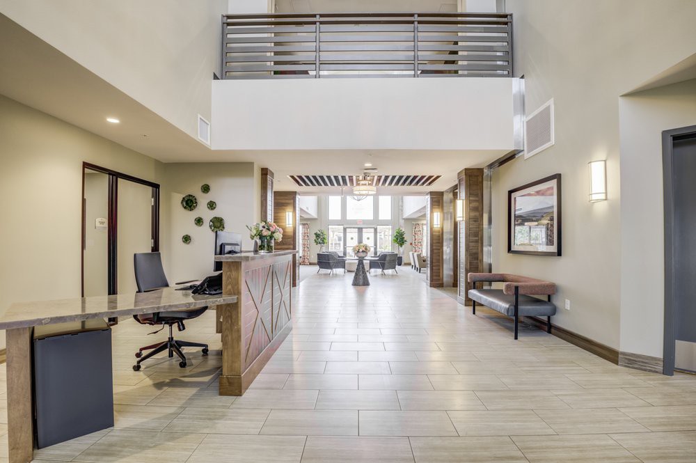 A modern lobby area with a reception desk, seating, and contemporary decor.