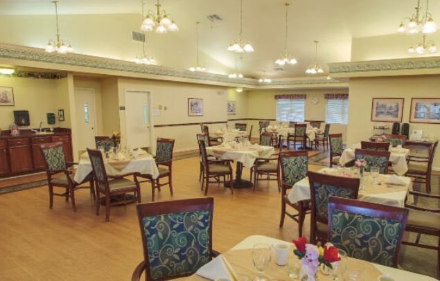 An elegantly decorated dining room with multiple tables set for guests.