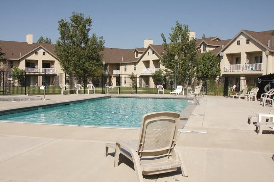 A serene outdoor swimming pool surrounded by residential apartments, perfect for relaxation.