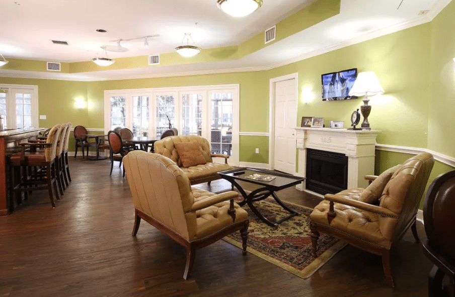 A cozy living room interior with comfortable seating and a fireplace.