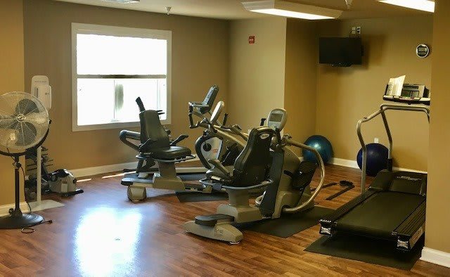 A small fitness center equipped with stationary bikes and cardio machines.