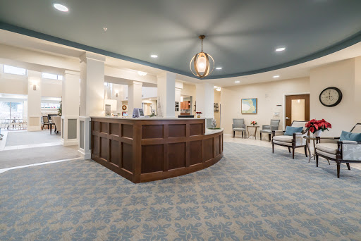 A modern hotel lobby featuring a welcoming reception desk and comfortable seating areas.