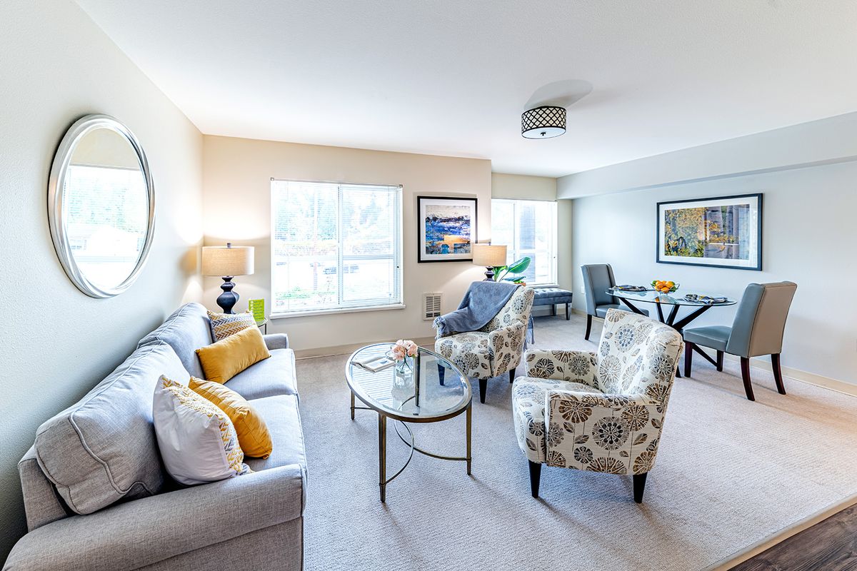A bright and modern living room with elegant furnishings and ample natural light.