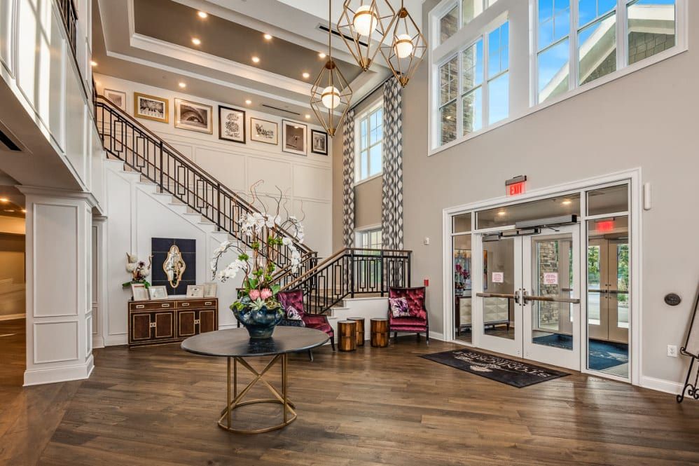 A beautifully designed lobby with a grand staircase and elegant chandelier.