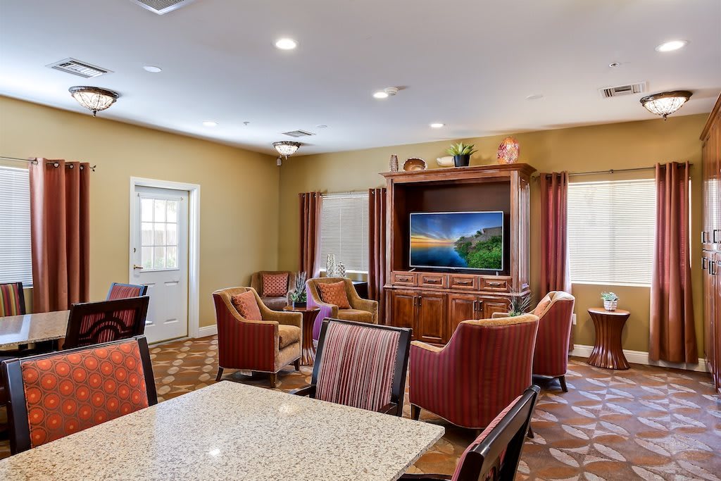 A cozy living room with comfortable seating and a large TV, perfect for relaxation.