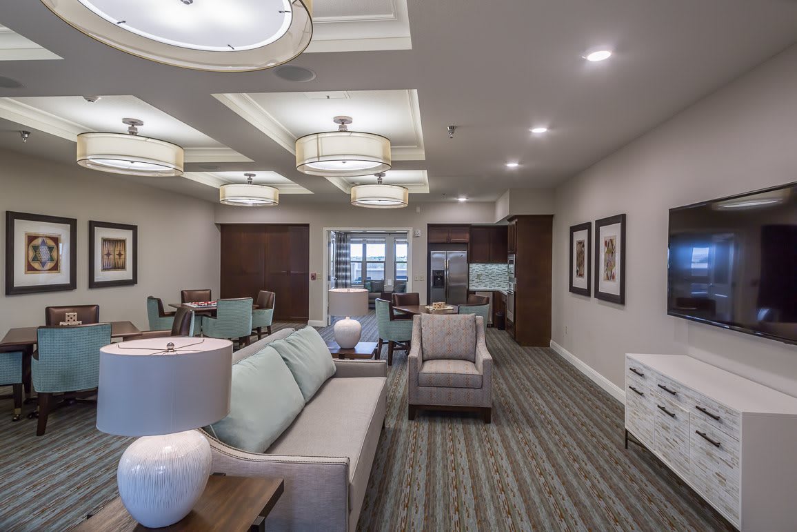 A modern living room interior with comfortable seating and elegant lighting.