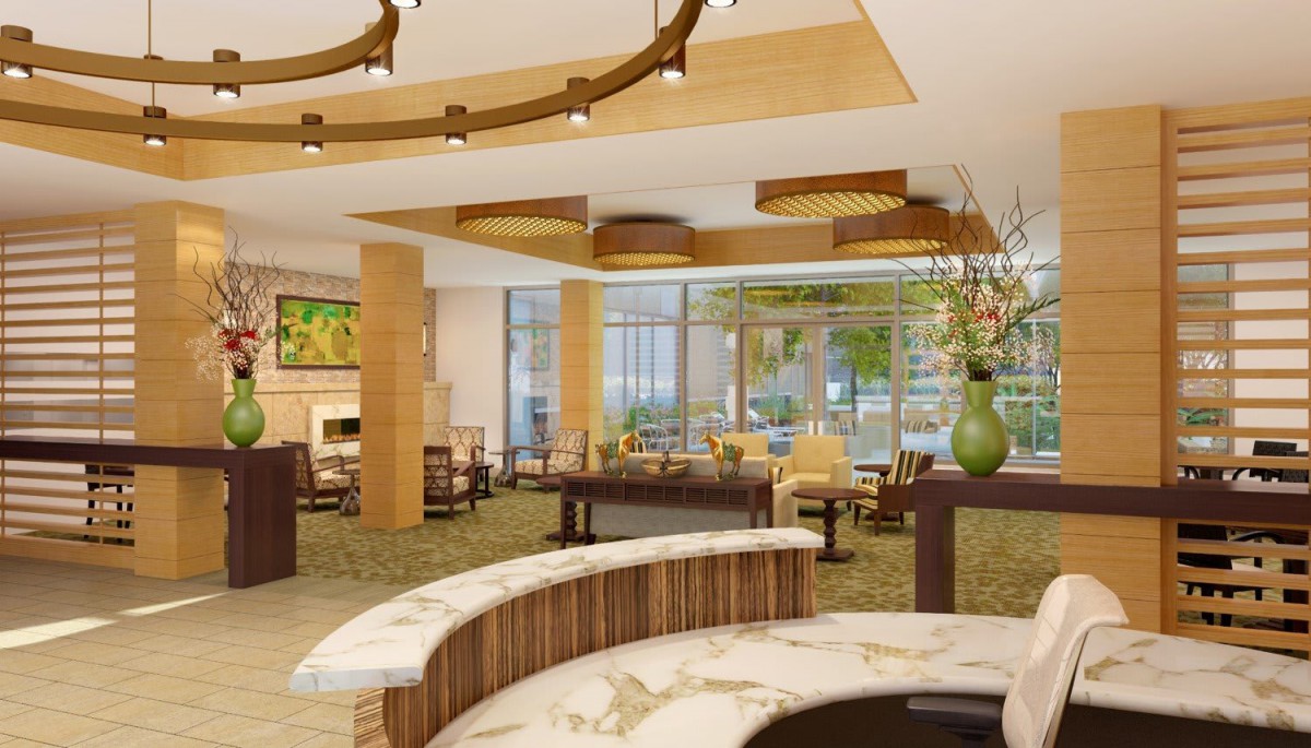A modern hotel lobby with elegant furnishings and natural lighting.