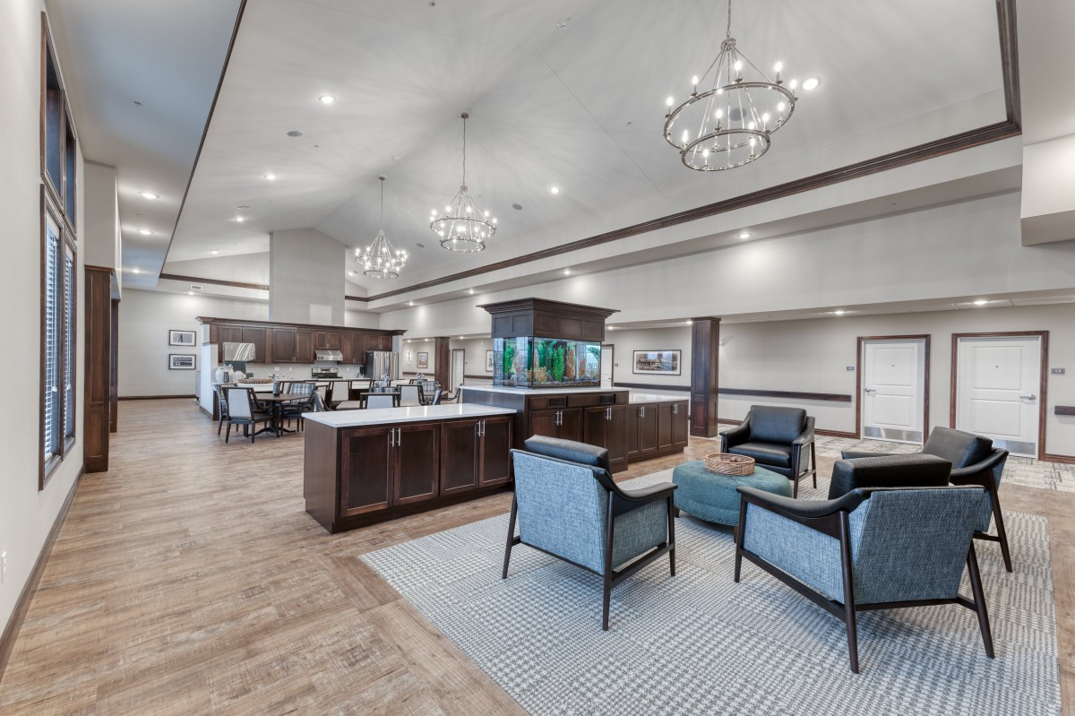 A modern lobby with elegant chandeliers and comfortable seating.