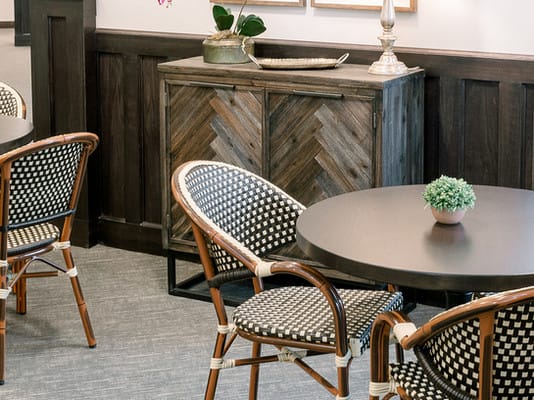 A cozy interior with stylish chairs, a table, and decorative elements.