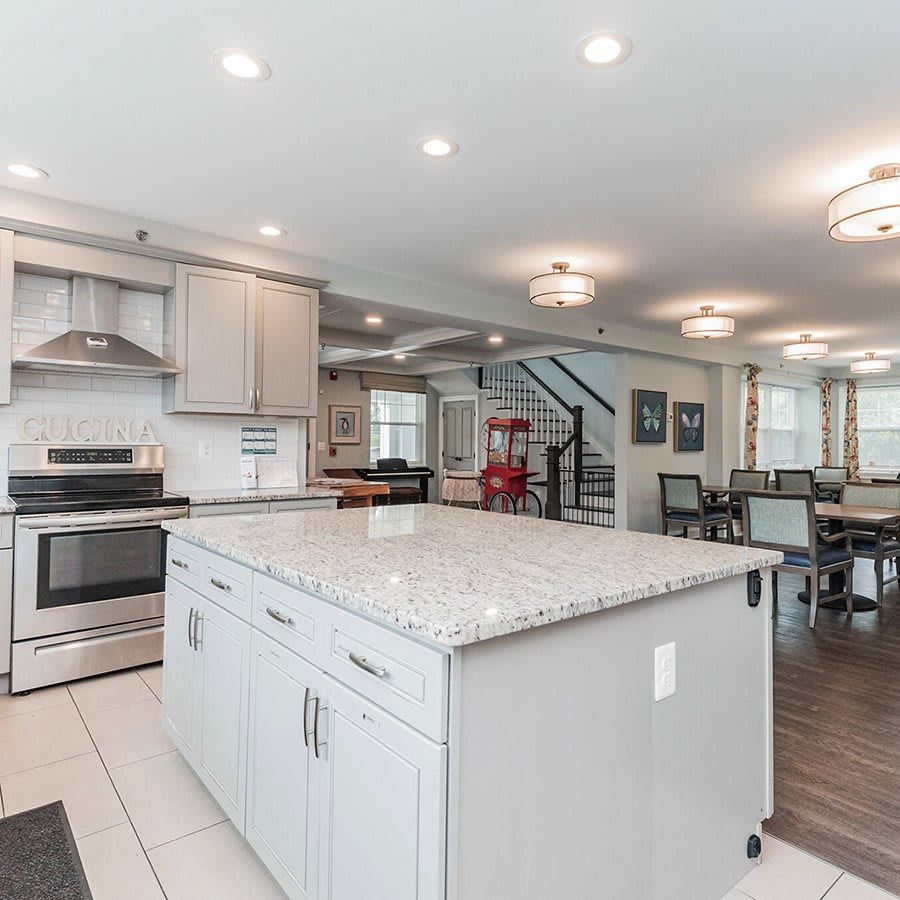 A modern open-concept kitchen with a large island and stainless steel appliances, seamlessly transitioning into the living and dining areas.